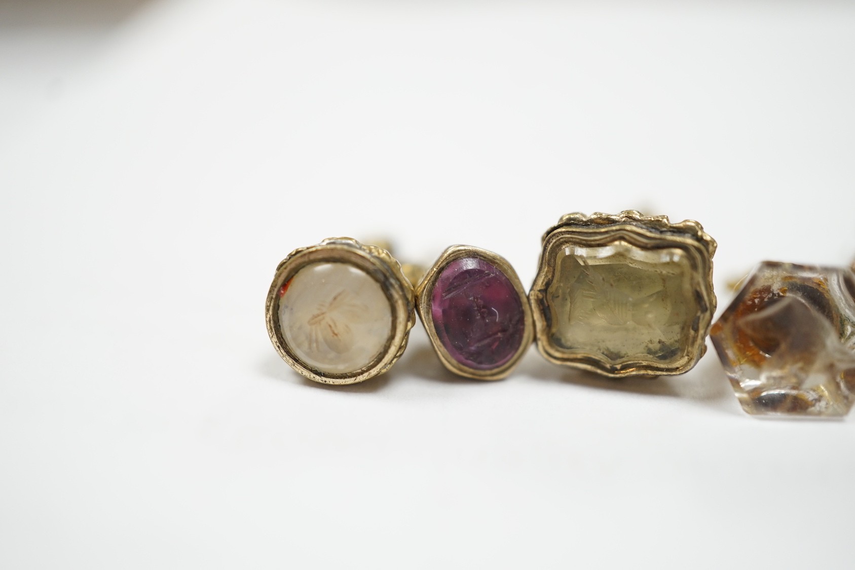 A collection of twelve small 19th century mainly yellow metal fob seals, with assorted matrices including bloodstone, amethyst, citrine and carnelian, largest 22mm.